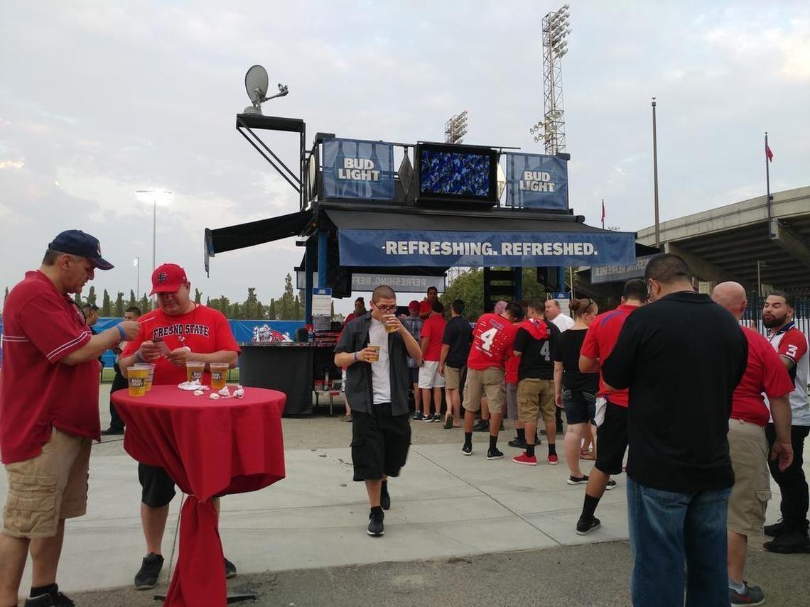 Fans line up for an $8 beer at one of two beer gardens set up within the boundary of Bulldog Stadium during the 2017 opener. Fresno State was able to sell alcohol in the stadium for the first time since 2006, an annual boost of more than $100,000 to the Bulldogs’ athletics department.