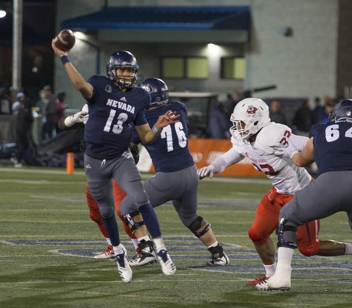 Nevada quarterback Cristian Solano rolls out against Fresno State pressure in the first half. Solano, making his first start, was 22 of 43 for 195 yards and three interceptions.