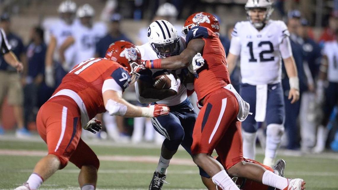 Fresno State defensive tackle Nathan Madsen, left, and linebacker James Bailey tackle BYU’s Squally Canada at the line of scrimmage during a 20-13 victory at Bulldog Stadium on Saturday, Nov. 4, 2017. The Bulldogs’ run defense is ranked third in the Mountain West, allowing 122.8 yards per game. Fresno State also has allowed just nine rushing touchdowns, fewest in the conference.