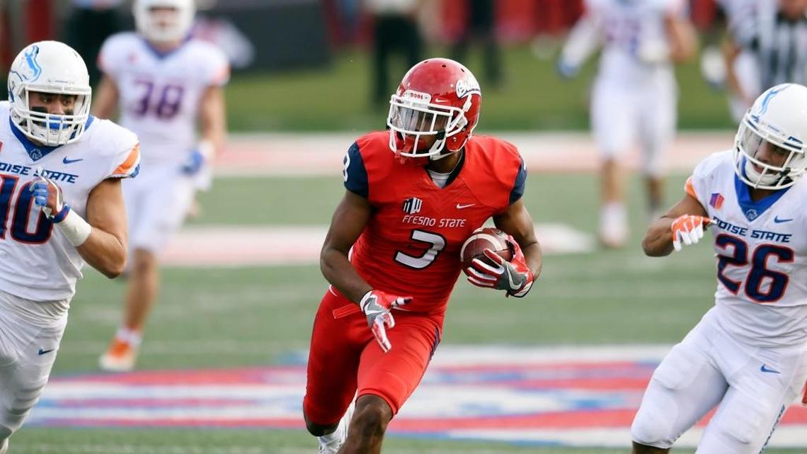 Fresno State’s KeeSean Johnson runs for a touchdown with Boise State’s Kekoa Nawahine, left, and Avery Williams struggling to keep up Saturday, Nov. 25, 2017.