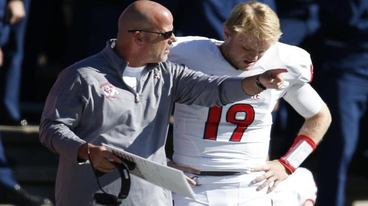 Fresno State offensive coordinator Dave Schramm, left, confers with quarterback Kilton Anderson during the second half of an Oct. 24, 2015, game at Air Force. The Bulldogs, thanks to ineffectiveness and injury, have rotated through four quarterbacks this season and rank last in the Mountain West Conference in total offense at 307.6 yards per game.