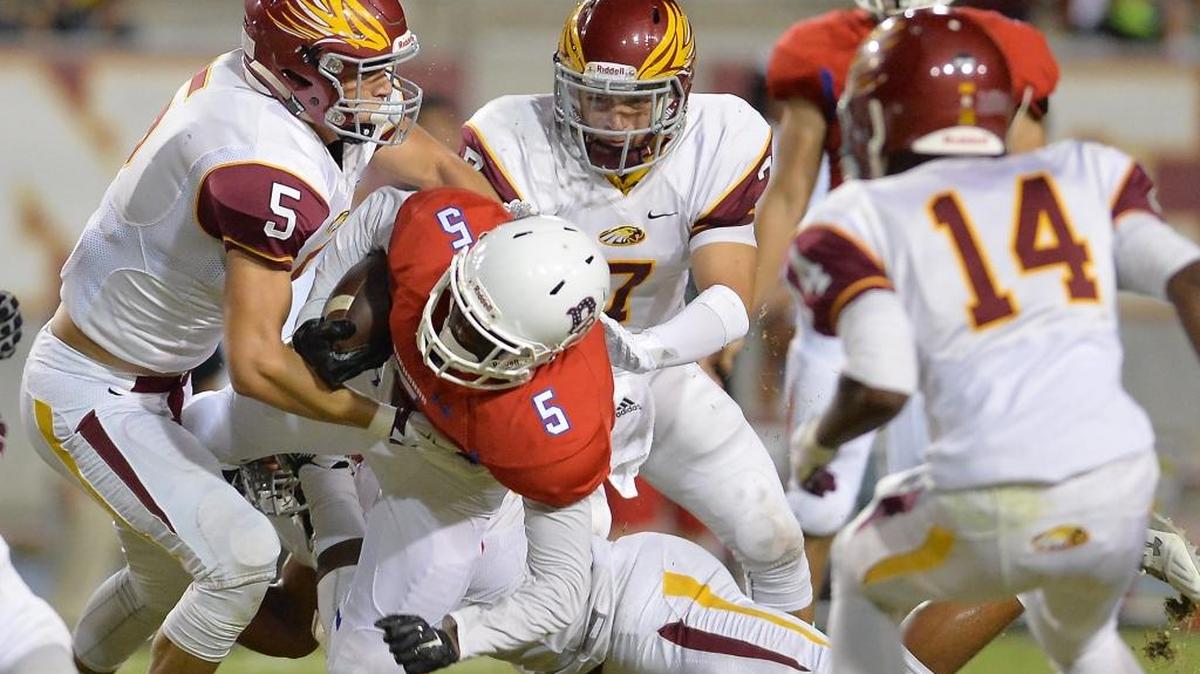Clovis West High’s Johnny Rojas (5) and Trace Garabedian (7) combine to take down Buchanan’s Chibuikem Dunu during an October 2015 game at Veterans Memorial Stadium. Rojas piled up 92 tackles as a senior defensive end for the Golden Eagles but is ticketed to play tight end at Fresno State.