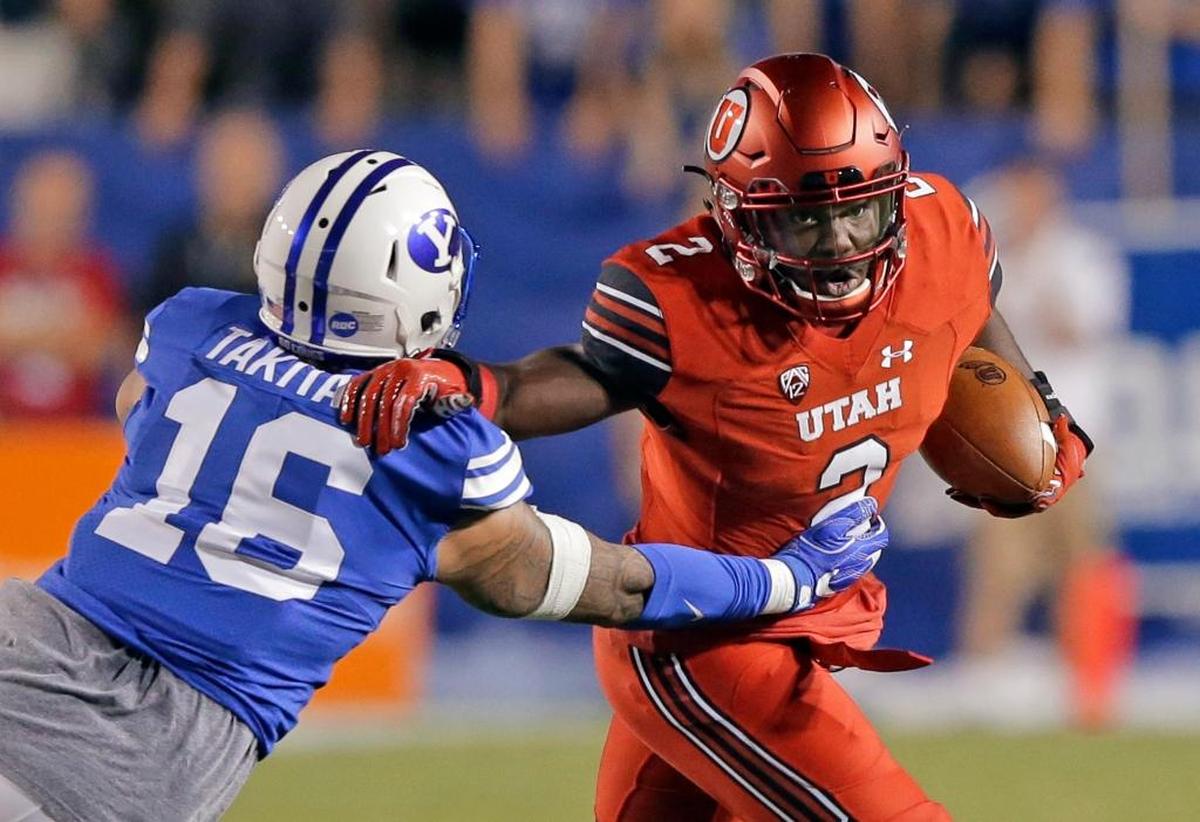 BYU defensive end Sione Takitaki takes down Utah running back Zack Moss (2) in the Cougars’ 19-13 loss on Sept. 9, 2017 in Provo, Utah. Takitaki is leading BYU in tackles for loss, sacks and quarterback hurries.