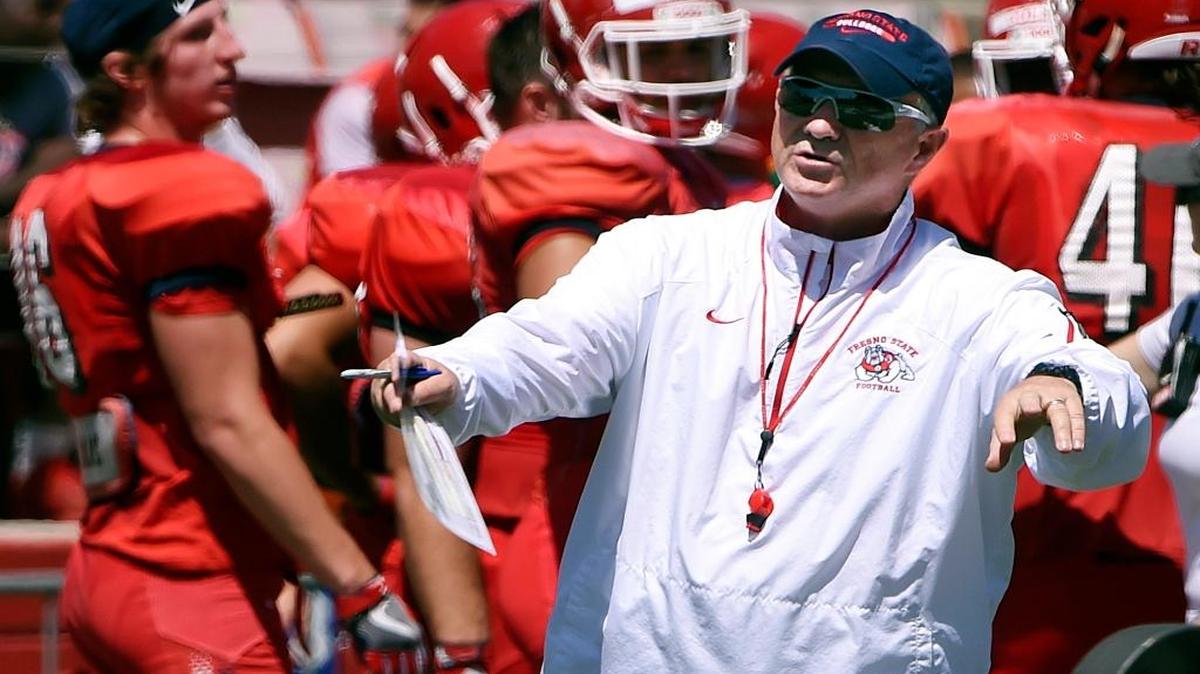 Fresno State coach Jeff Tedford, center, calls out instructions during Spring Preview, capping off spring football training in front of fans at Bulldog Stadium Saturday, April 29, 2017 in Fresno, Calif.