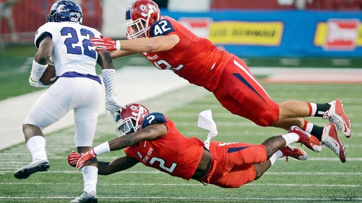 
Fresno State linebacker Jeff Camilli goes high as Jamal Ellis goes low to stop Abilene Christian’s De’Andre Brown in the 2015 season opener. Camilli will be key to the Bulldogs’ run defense bouncing back after allowing nearly 300 rushing yards in a Week 4 loss to San Jose State.
