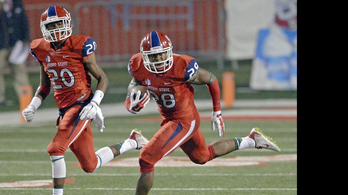 
Fresno State’s Charles Washington, right, returns an interception against San Jose State with the help of teammate Malcolm Washington on Nov. 8, 2014.
