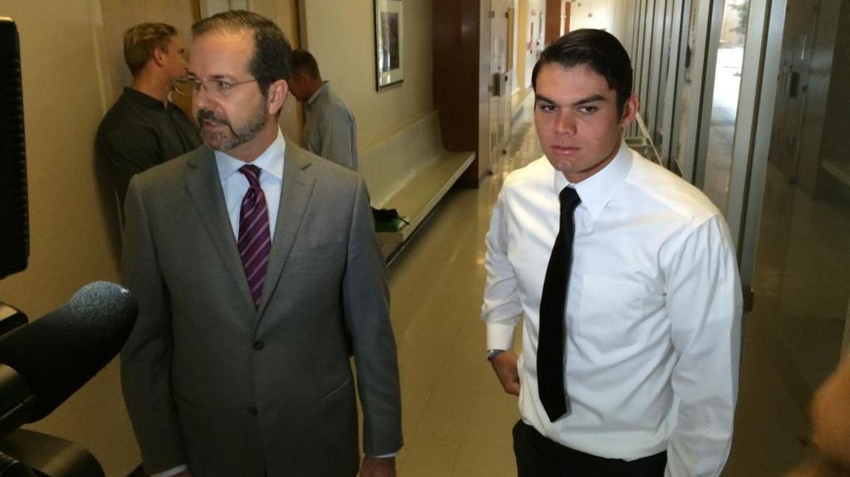 Fresno State quarterback Zack Greenlee, right, and his attorney, Jeff Hammerschmidt talk to reporters after Greenlee and linebacker Brandon Hughes pleaded no contest to misdemeanor charges stemming from a Sept. 20 incident when police broke up a loud house party near the campus. Hughes, behind Hammerschmidt, declined to comment.