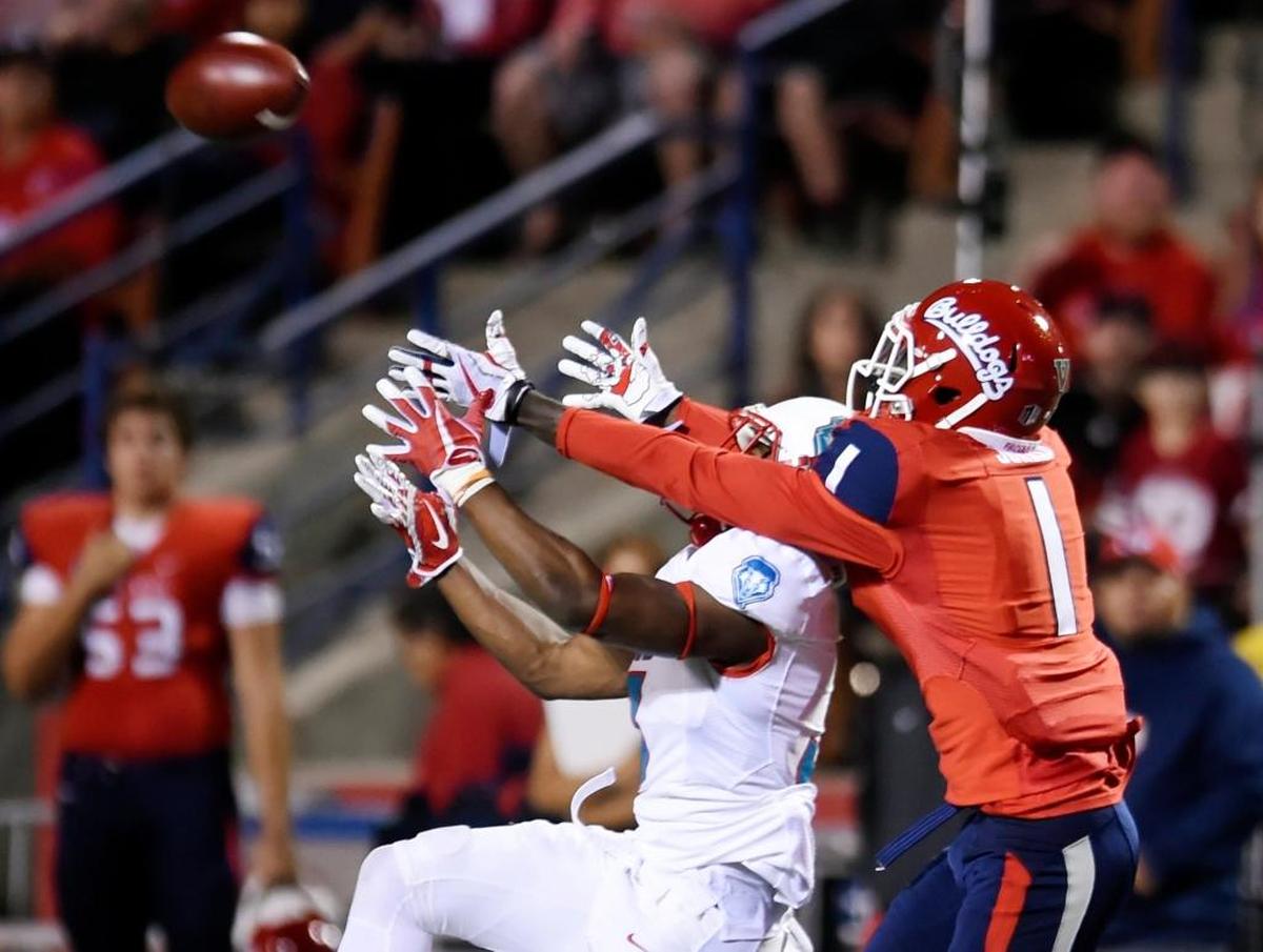 New Mexico’s D’Angelo Ross, left, breaks up the pass to Fresno State wideout Jamire Jordan, right, in first half of the Bulldogs’ 38-0 victory over the Lobos Saturday, Oct. 14, 2017 in Fresno. Jordan caught three passes for 105 yards including touchdowns of 70 and 32 yards from quarterback Marcus McMaryion. It was the first time Jordan had two touchdown receptions in a game.
