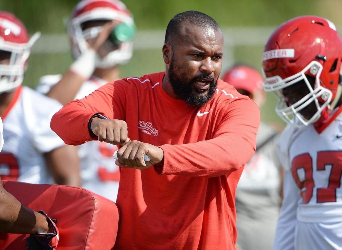 Fresno State defensive line coach Jamar Cain runs the Bulldogs through a drill in practice.