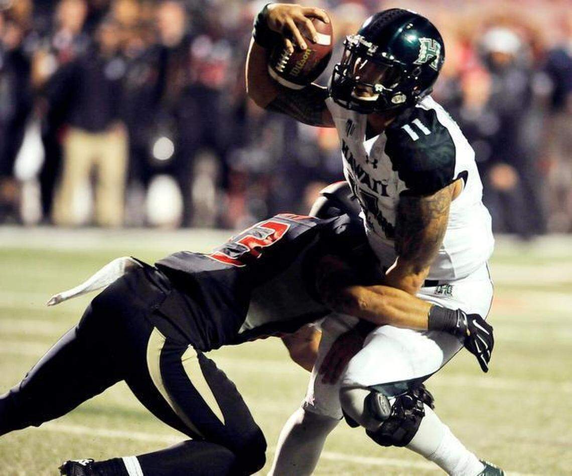 Fresno State safety Derron Smith sacks Hawaii quarterback Ikaika Woolsey late in Saturday’s game at Bulldog Stadium. The Bulldogs’ 28-21 victory sent them back to the Mountain West Championship game for a second straight season.