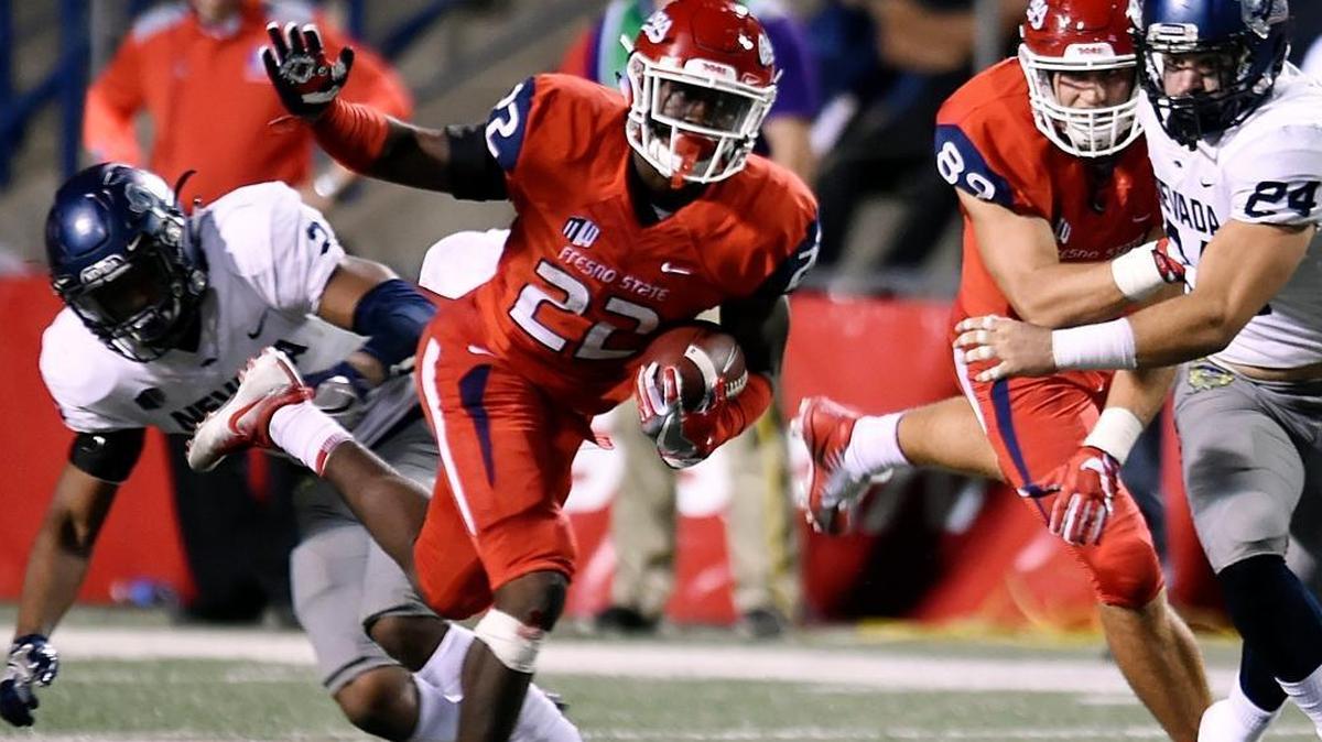 Fresno State freshman running back Jordan Mims, center, makes a cut to get away from Nevada’s Asauni Rufus, left, in the Bulldogs’ 41-21 victory on Saturday, Sept. 30, 2017 in Fresno. Mims has been the Bulldogs leading rusher in their past two games, gaining 112 yards in a win at San Diego State and 68 yards with two touchdowns in a loss to UNLV.