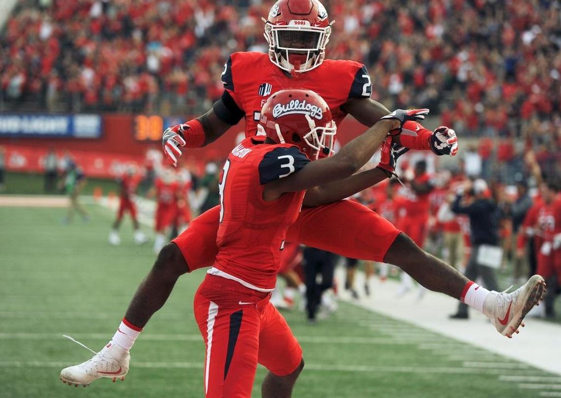 Fresno State running back Jordan Mims (22) celebrates with KeeSean Johnson after Johnson scored on an 81-yard touchdown pass from Marcus McMaryion in the a 28-17 victory over Boise State on Saturday, Nov. 25, 2017. Johnson caught six passes for 119 yards and two touchdowns.