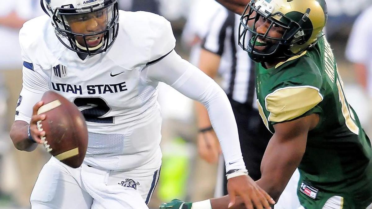 
Utah State quarterback Kent Myers scrambles out of the pocket as Colorado State safety Trent Matthews chases after him on Oct. 3 in Logan, Utah. 
