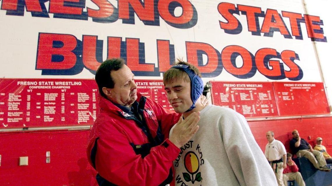

Fresno State wrestling coach Dennis DeLiddo preps the Bulldogs’ three-time NCAA champion, Stephen Abas, during the 2002 NCAA regionals at Fresno State’s North Gym. 
