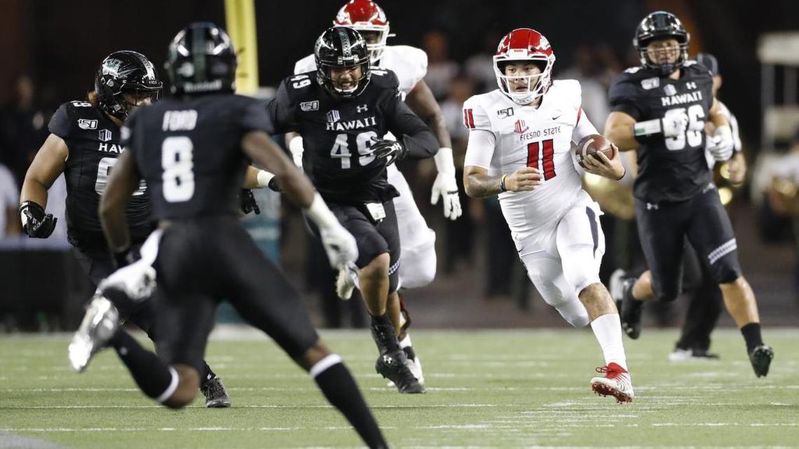 Fresno State quarterback Jorge Reyna runs through the Hawaii defense in the second half Saturday night.