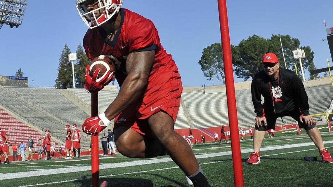 Fresno State running back Dontel James hits the hole with power on the first day of 2016 spring practice.