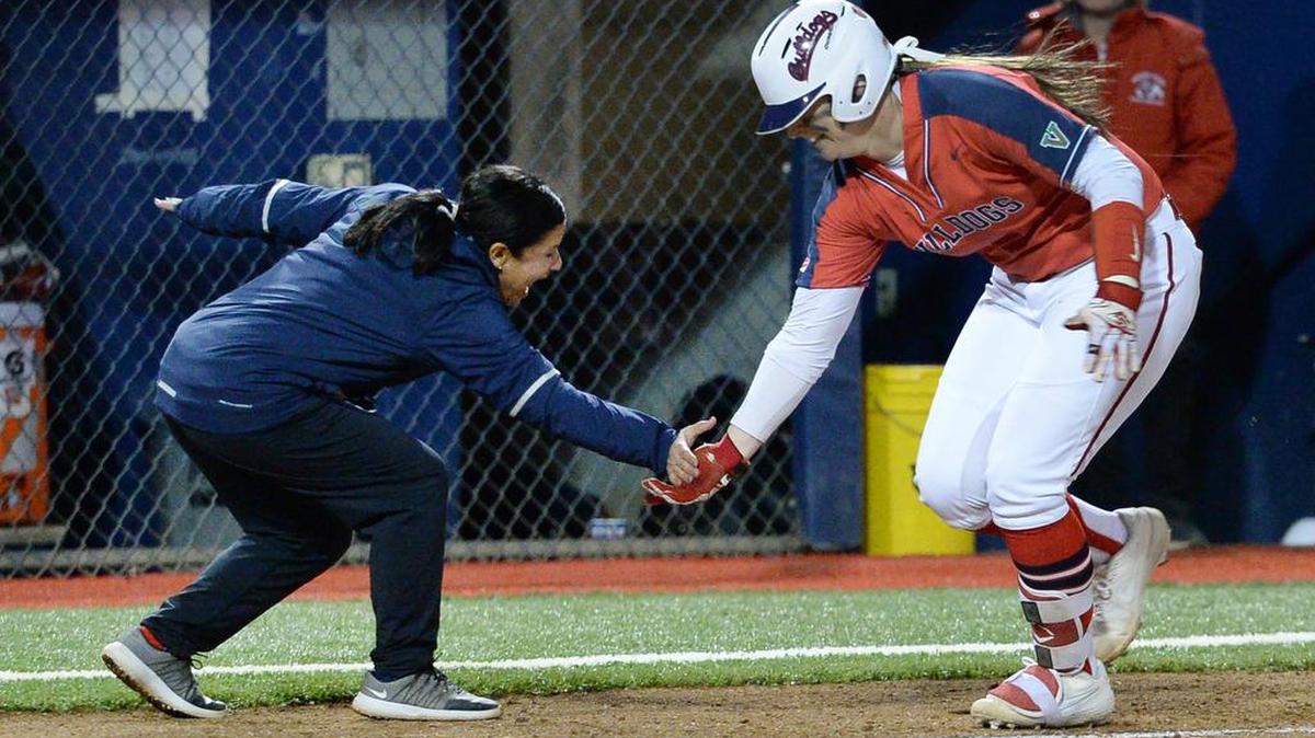 Fresno State’s Kelcey Carrasco, right, is congratulated by coach Linda Garza after hitting a home run against Montana in the Bulldog Classic tournament at Margie Wright Diamond on Friday, March 8, 2019.