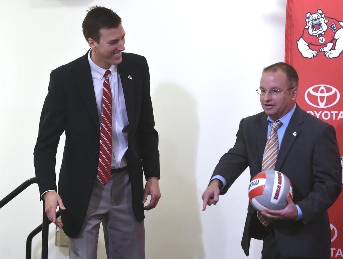 Fresno State interim athletics director Steve Robertello, right, welcomes Jonathan Winder, left, as the new women’s volleyball coach during a news conference Friday, Jan. 26, 2018 in Fresno.