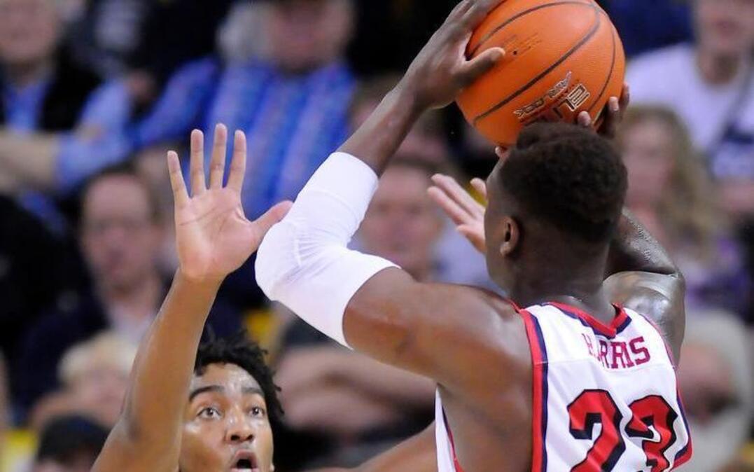 Fresno State guard Marvelle Harris shoots over the defense of Utah State guard Chris Smith in the teams’ Mountain West Conference game Saturday in Logan. Harris scored 34 points en route to setting the school scoring record in the Bulldogs’ regular season-closing 86-85 win. (/via AP) MANDATORY CREDIT