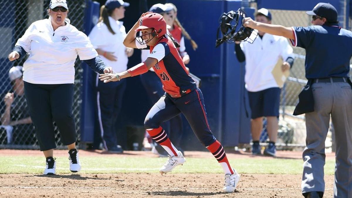 Fresno State’s Christina Rodriguez runs home after an overthrown ball to third base by Utah State in the series finale Sunday. Fresno State won, 2-1.