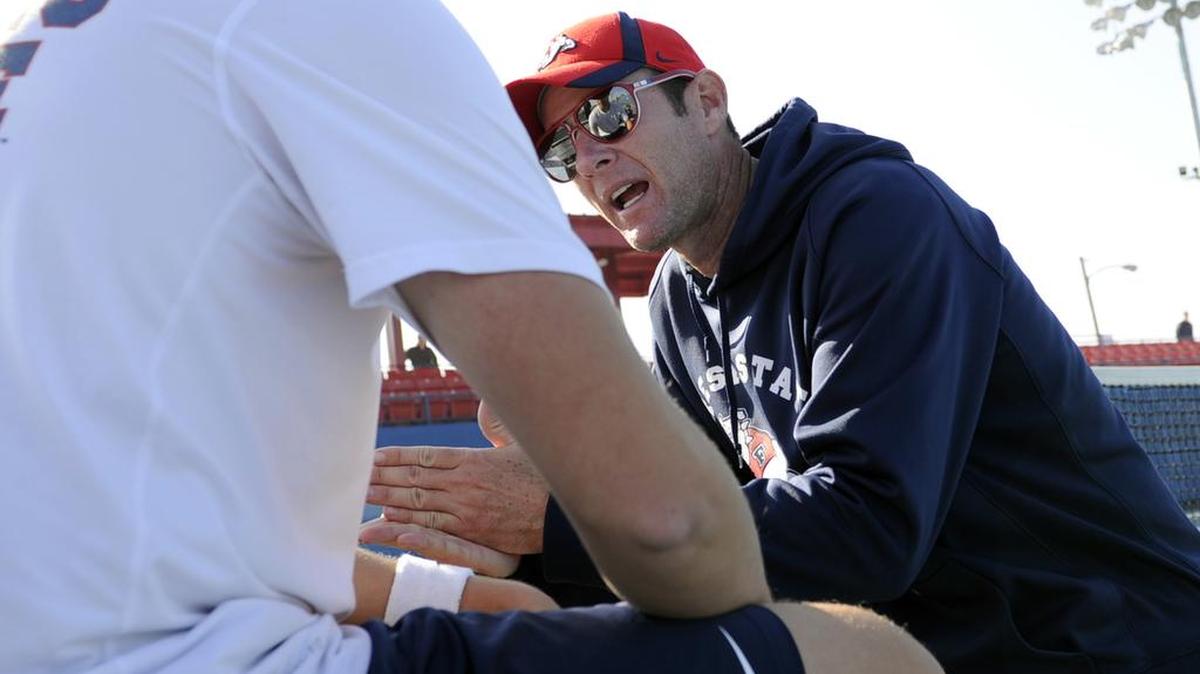 
Fresno State men’s tennis coach Evan Austin instructs a player during a match in 2013. Austin has resigned after three seasons as coach.
