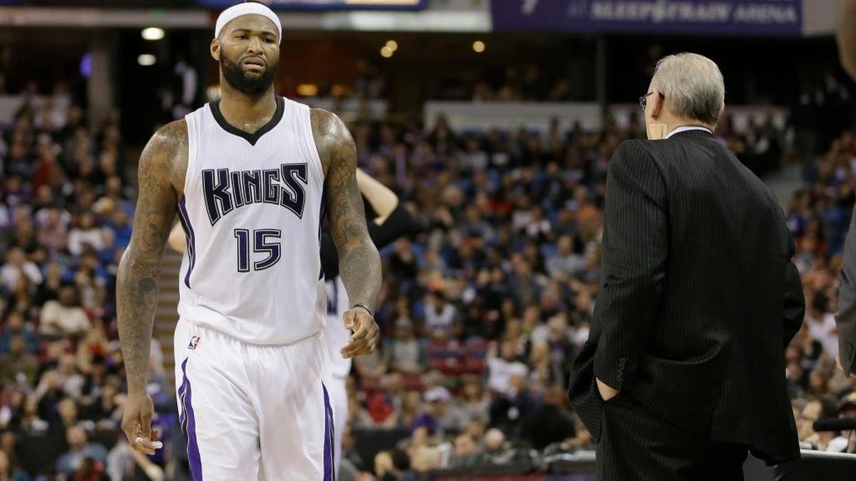 Kings center DeMarcus Cousins passes coach George Karl, right, as he walks to the bench Sunday, March 13, 2016, in Sacramento.