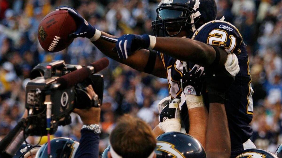 San Diego Chargers running back LaDainian Tomlinson (21) is carried by teammates after scoring his 29th touchdown of the season, breaking the NFL single-season record, in the fourth quarter of the Chargers 48-20 victory over the Denver Broncos in their football game in San Diego on Sunday, Dec. 10, 2006.