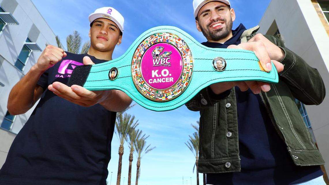 WBC super lightweight champion Jose Ramirez, right, and Gabriel Flores Jr. hold the “KO Cancer” belt.