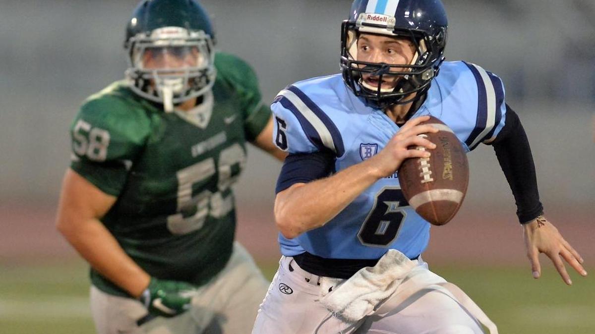 Quarterback Jack Taylor, scrambling away from Dinuba’s Joshua Grajeda in a scrimmage on Aug. 18, is a two-year starter who has helped elevate Bullard to No. 2 in The Fresno Bee’s Central Section football rankings.