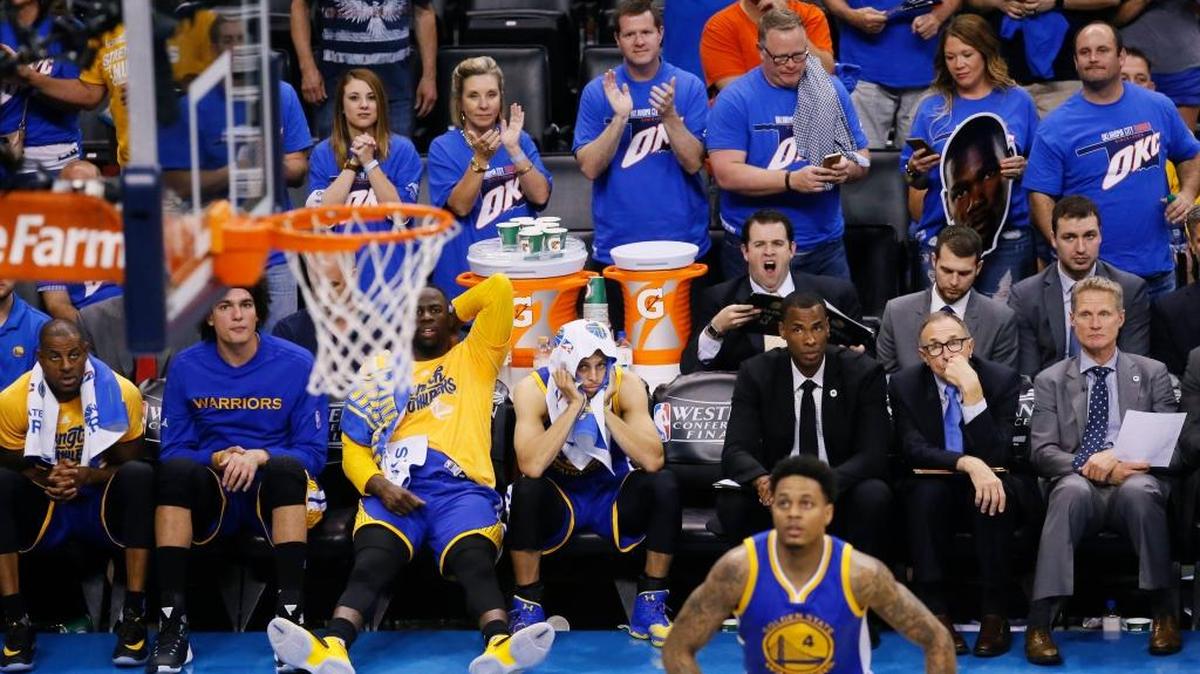Golden State Warriors personnel – including Stephen Curry, center – watch from the bench during the second half of Game 3 of the NBA basketball Western Conference finals against the Oklahoma City Thunder in Oklahoma City on Sunday, May 22, 2016. Oklahoma City won 133-105 to take a 2-1 series lead.