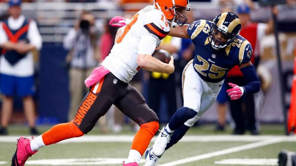 Cleveland quarterback Josh McCown runs with the ball as St. Louis strong safety T.J. McDonald (Edison) defends during the first quarter of the teams’ Oct. 25 game. McDonald finished with eight tackles and forced a fumble.