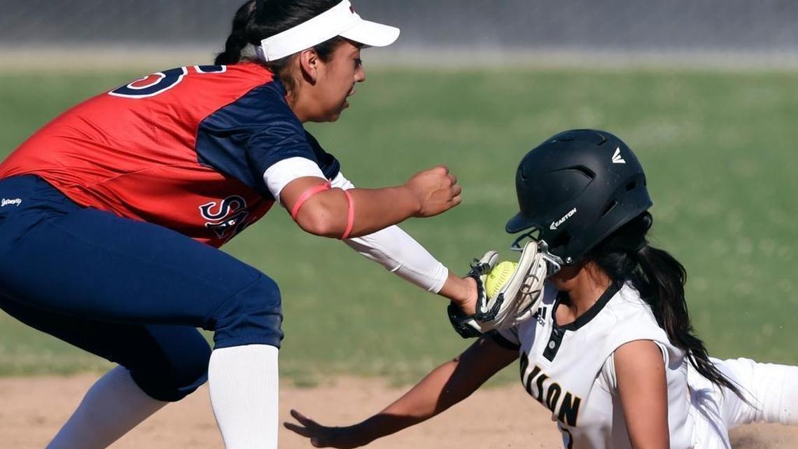 Sanger’s Vanessa Hernandez, left, tags out Edison’s Isabella Gomez, right, at second base in a 2017 Central Section Division II softball semifinal. Sanger advanced to the finals 11-1 over Edison. Hernandez will sign with Fresno State.