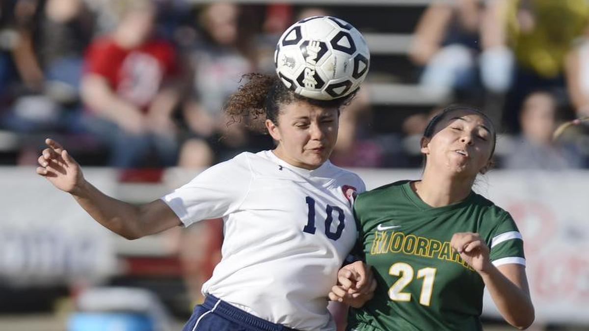 Strathmore's Rosalinda Platas, left, tries to head the ball away as Moorpark's Danielle Boggess defends in their Southern California regional playoff game at Stathmore on Thursday, March 10, 2016.