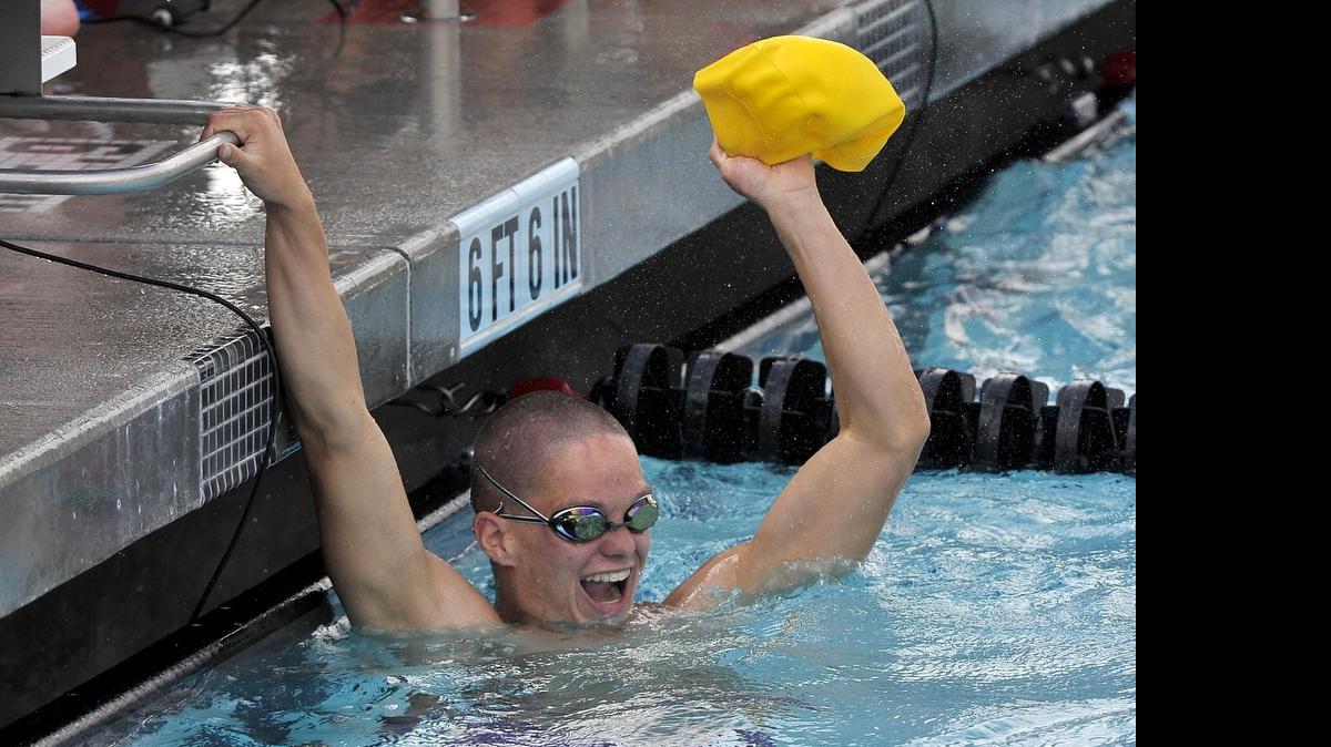 
Clovis’ Graham Hauss celebrates after finishing off the anchor leg of the winning 200 freestyle relay at the state championships.
