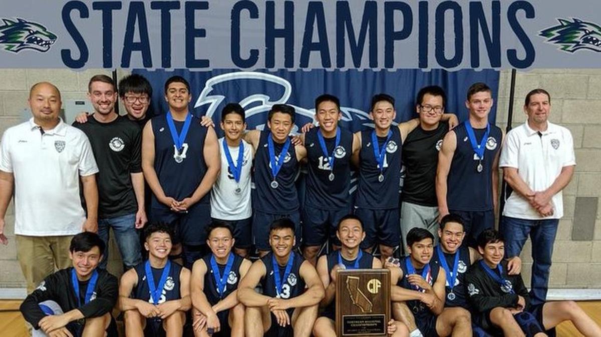 The Clovis East boys volleyball team celebrates winning the Northern California Regional Division II championship on Saturday, May 18, 2019.