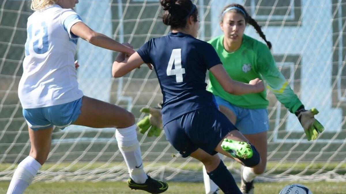 Bullard High’s Jordyne Puentes, center, gets free from Clovis North’s Tiffany Jones before kicking the ball past Angie Petrakis for the game-winner in the 80th minute of their Central Section Division I championship match on Saturday, Feb. 25, 2017, at Clovis North.