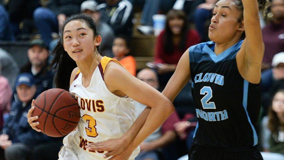 Clovis West's Nikki Tom, left, dribbles around Clovis North's Savannah Tucker before taking a shot at the hoop during their game with Clovis West at Clovis West on Friday, Jan. 18, 2019. Clovis West beat Clovis North.
