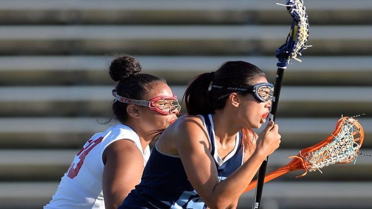 McLane High’s Tatianna Washington, left, and Bullard’s Megan Ebert duel in Thursday’s Fresno League lacrosse championship. Ebert scored five goals as the Knights won the title game 12-8.