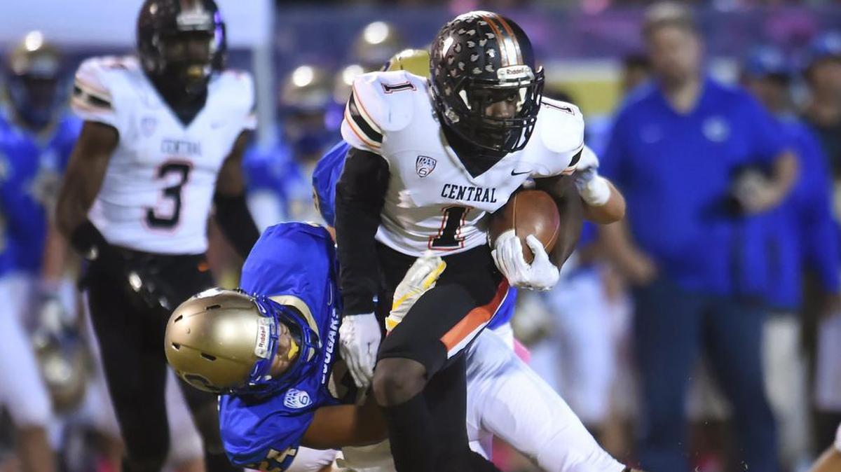 Central High wide receiver Xavier Worthy, right, is brought down by Clovis High’s Isaac Aceituno, background, in a matchup Thursday night, Oct. 9, 2019 in Clovis. Central beat Clovis High 56-14 at Lamonica Stadium.