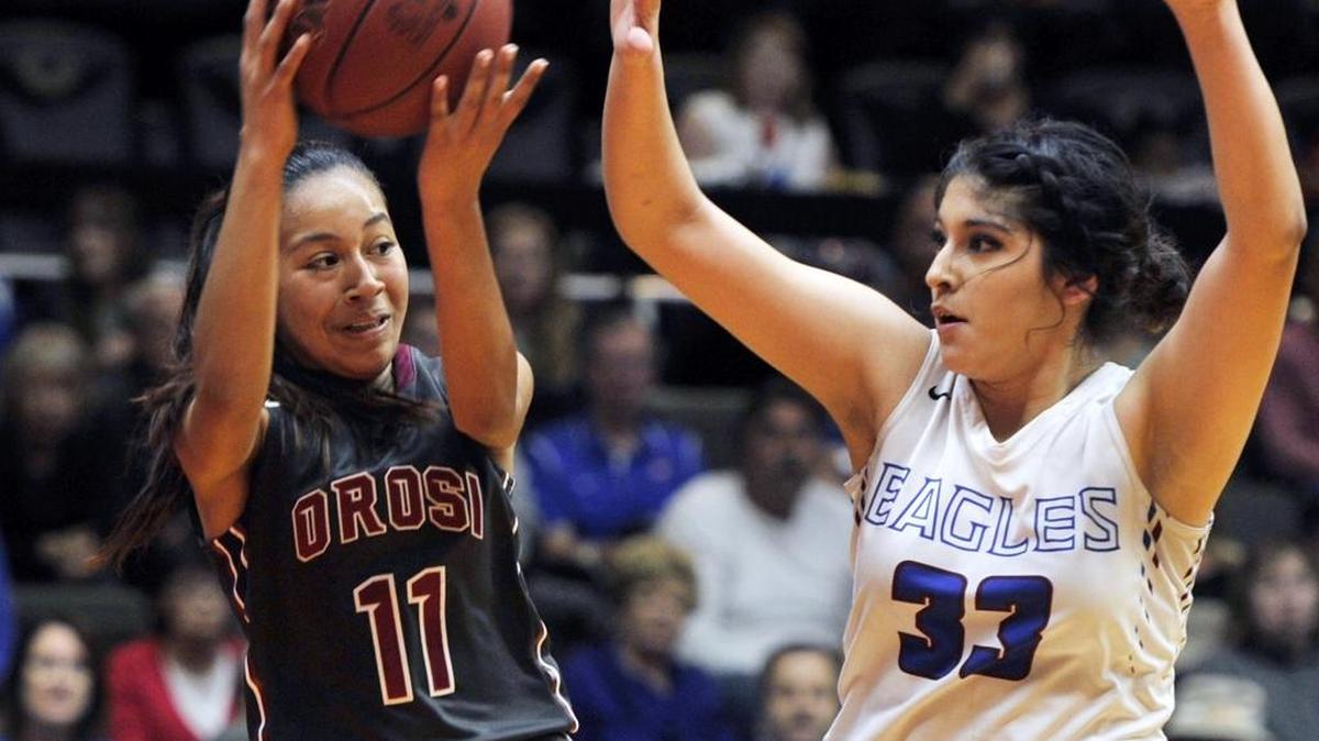 Immanuel’s Krystale Gutierrez, right, in action against Orosi in the 2016 Central Section championship game, scored 24 Tuesday night to help the Eagles open the season with a 53-43 win over Edison.