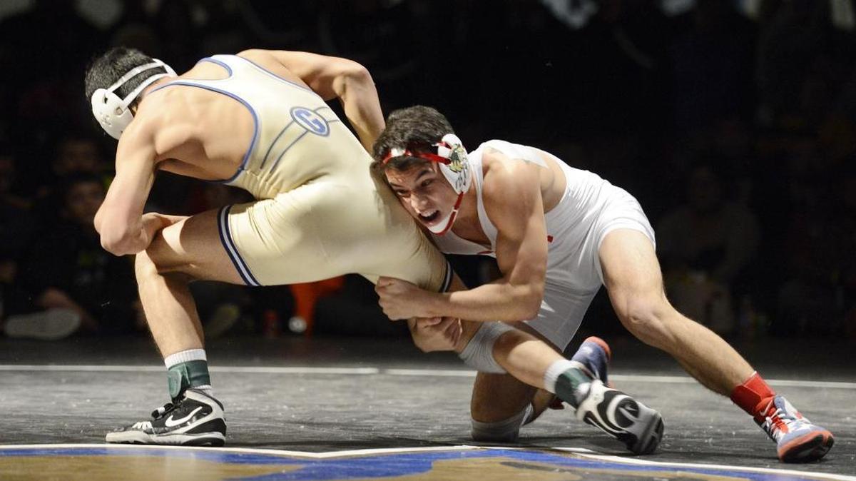 Buchanan High’s Durbin Lloren, right, tries to pull down Alex Felix of Gilroy in the 132-pound final at the Doc Buchanan Invitational on Saturday at the Clovis gym. Lloren defeated Felix 3-1 in a matchup of the state’s Nos. 1-2 ranked wrestlers at that weight.