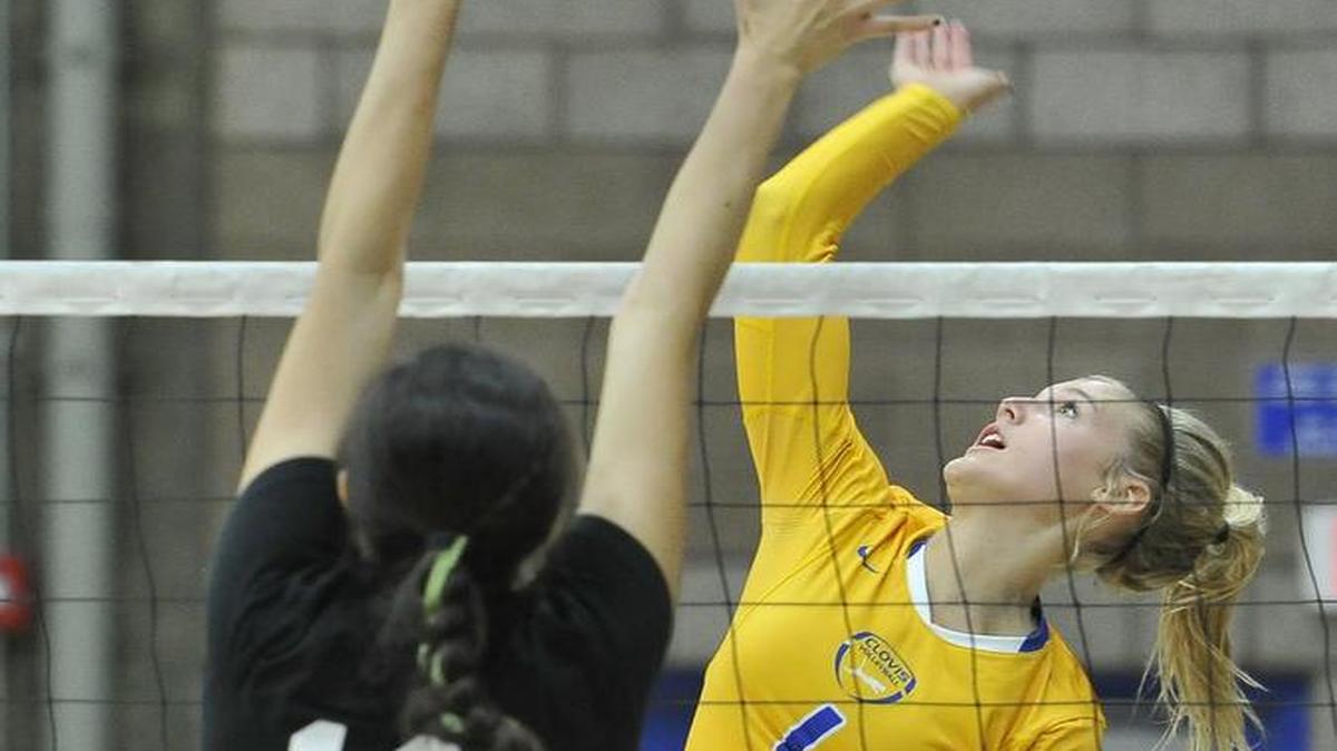 
Clovis High’s Taylen Ballard spikes against Granada Hills’ Sarah Hagge on Sept. 6, 2015.
