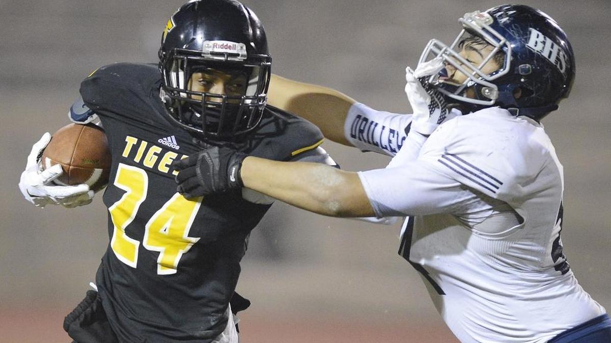 Edison’s Jimmy Gray, left, stiff-arms his way past Bakersfield's Chris Agtang in their first-round Division I playoff game at Sunnyside High School Stadium Friday, Nov. 13, 2015. Gray is one many players that will play in the City/County All-Star game on June 16 at Lamonica Stadium.