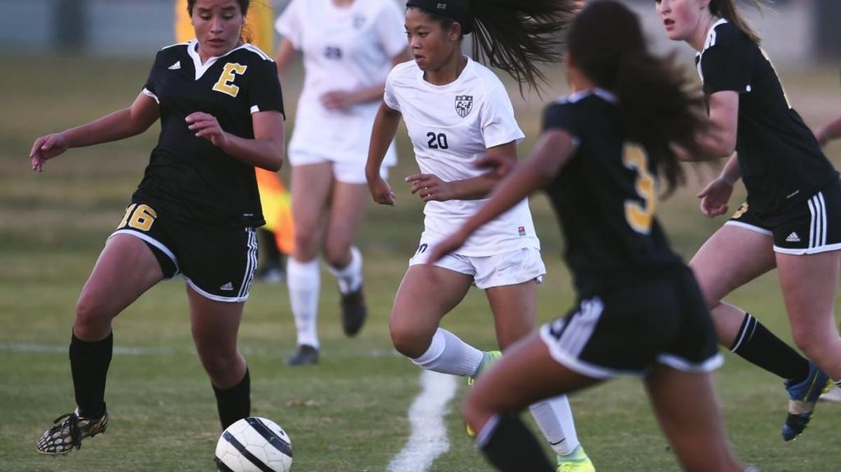 Edison High’s Ariana Quintero, left, Mia Lopes, foreground, and Laura Larsen, far right, try to stop Clovis East’s Isabella Keomounpane on a drive to the goal Wednesday, Nov. 30, 2016. Clovis East won 4-0 in its season opener, while the Tigers fell to 1-1.