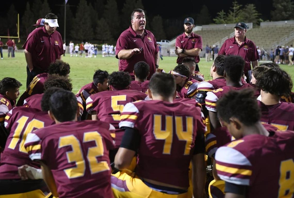 Clovis West coach George Petrissans, top center, gives a pep talk to the team after Central Catholic-Modesto shut out the Golden Eagles 21-0 Friday, Aug. 17, 2018 in Clovis.