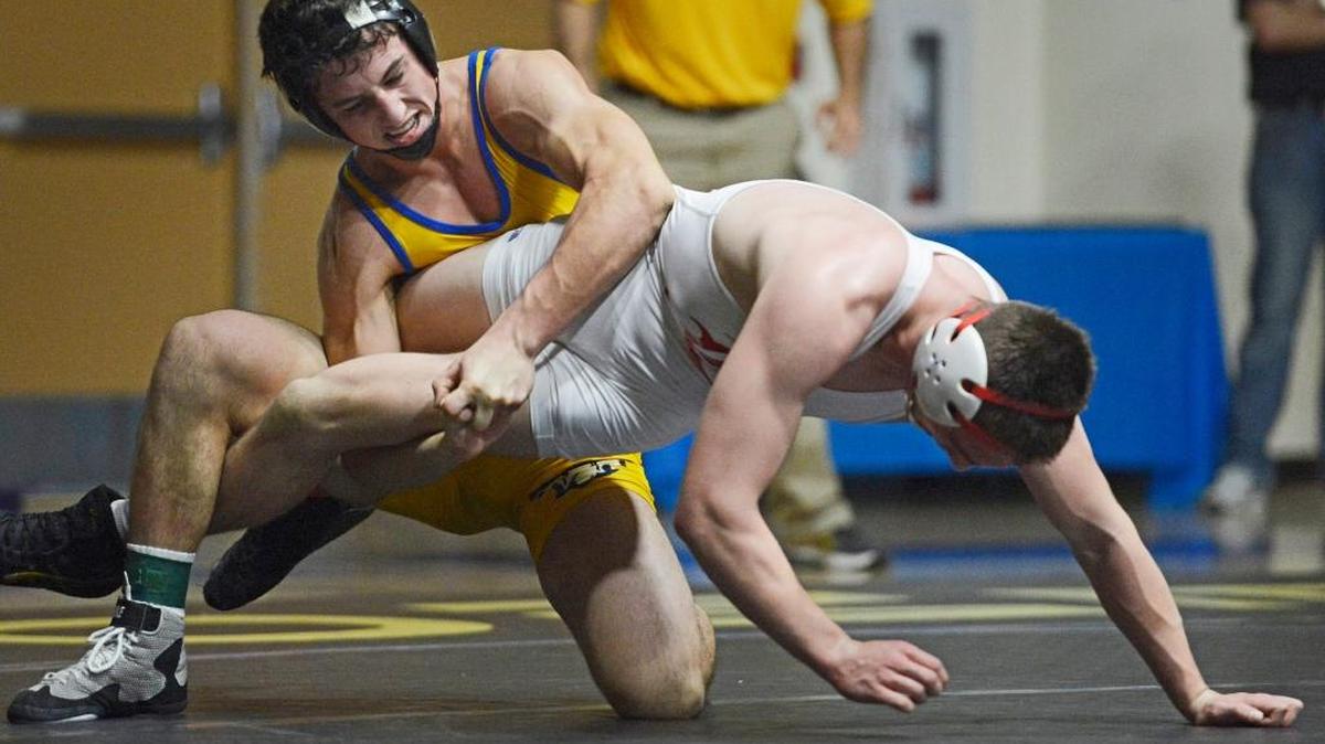 Clovis High’s Jared Hill, left, will take his skills on the wrestling mat to Stanford.