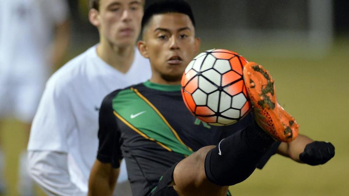 Roosevelt’s Julian Yepiz, makes contact with the ball in front of Clovis West’s Cameron Hustedde in a non-league boys soccer match at Tice Park on Wednesday, December 9, 2015 in Fresno, California. Roosevelt beat Clovis West 3-1.