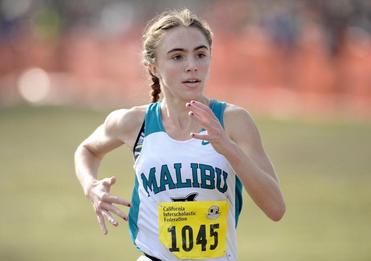 Malibu’s Claudia Lane dashes for the finish line to win the girls Division IV race at the 2017 CIF State Cross Country Championships at Woodward Park in Fresno on Saturday, Nov. 25, 2017.