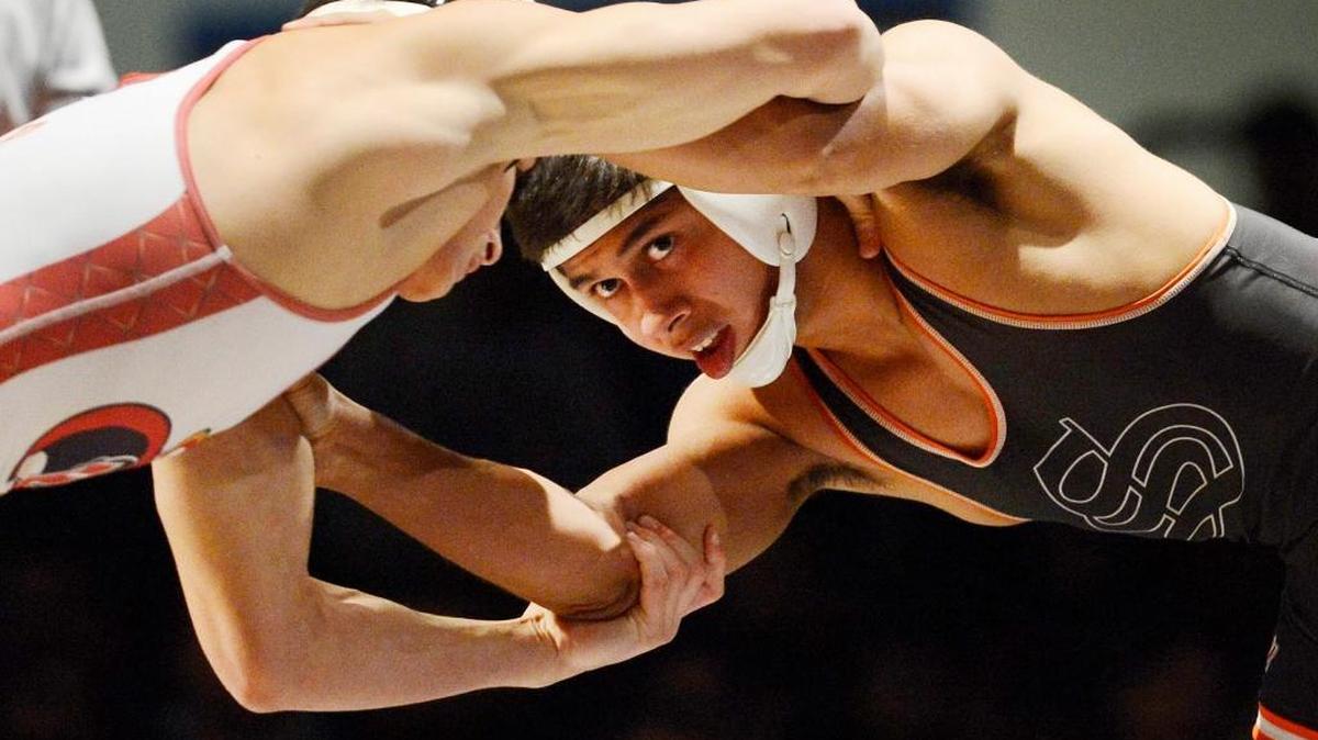 Selma High’s Robert Garcia, IV, right, wrestles Gerard Angelo of Bergen Catholic, New Jersey, in the 120-pound final Saturday at the Doc Buchanan Invitational. Angelo won 2-1.