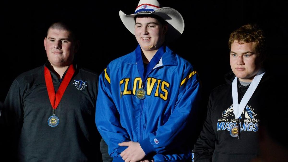 Clovis’ Seth Nevills, center, stands on top of the podium as the champion in the 285-pound final at the 2015 Doc Buchanan Invitational wrestling tournament. He goes for his fourth Doc title this weekend.